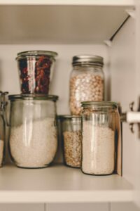 some jars in the kitchen cabin and there are uncooked rice stored in one Rice in Mason Jars